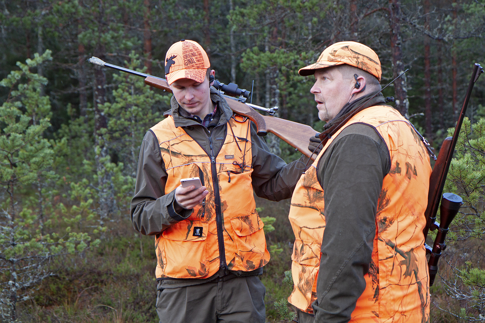 When Perttu and Juha-Matti Valonen go into the woods, what they never leave behind are binoculars. Orange hi-vis clothing is mandatory when hunting. Photo: Anna Kauppi